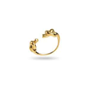 Bijou en acier inoxydable de couleur dorée composé d'un anneau se resserrant sur le dessus par deux petits noeuds
