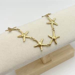 oli bracelet en acier inoxydable, hypoallergénique et sans nickel, composé d’une ribambelle de petits pendentifs en forme d'étoile de mer
