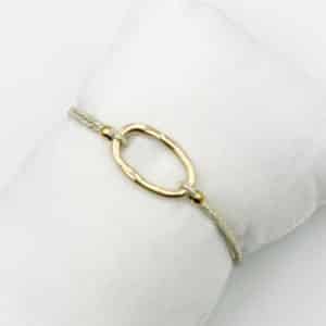 Bracelet monté sur élastique doré à noeuds coulants et petit pendentif rectangulaire